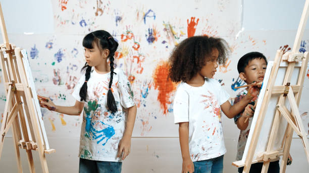 istock Diverse student painted or draw canvas at stained wall in art lesson. Erudition. 2152016231