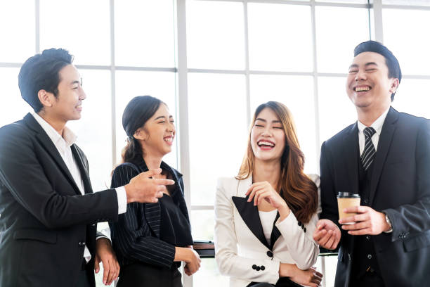 istock Asian business team smiling during talking and meeting while having a coffee break in the office. Asian business group brainstorm, share startup ideas and discuss new innovation with fun. 2152017834