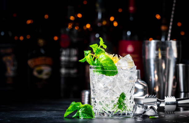 istock Summer refreshing drink cocktail with mint, lemon, vodka and gin tonic. Bar tools. Dark background bar counter 2152018256