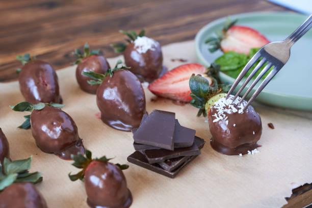 istock Chocolate dipped strawberries on a wooden table. Selective focus. 2152018379