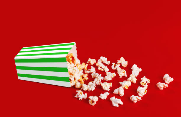 istock box with popcorn striped in different colors on a red background 2152018460