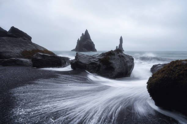 istock Reynisdrangar sea stack at Reynisfjara Beach, Vik, Iceland with moody sky 2152018492