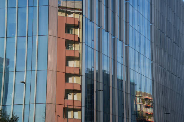 Milan, Italy - December 7, 2023: Milan, Lombardy, Italy: modern buildings along via Faravelli,  recently built, with reflections, in a sunny afternoon