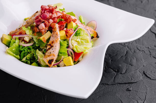 istock Fresh chicken and bacon salad on modern plate 2152021337