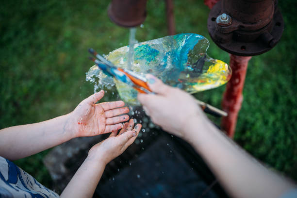istock Washing  hands and brushes after painting 2152021697