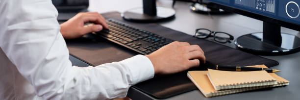 istock Office worker sitting on workspace desk typing on keyboard. Trailblazing 2152022052