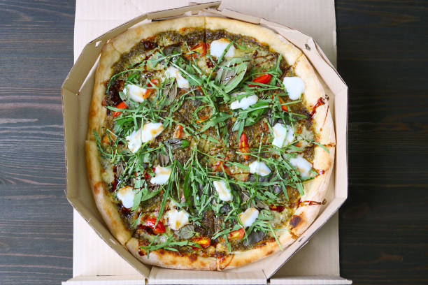 istock Delectable Margherita Pizza Topped with Arugula and Balsamic in a Paper Box 2152024044