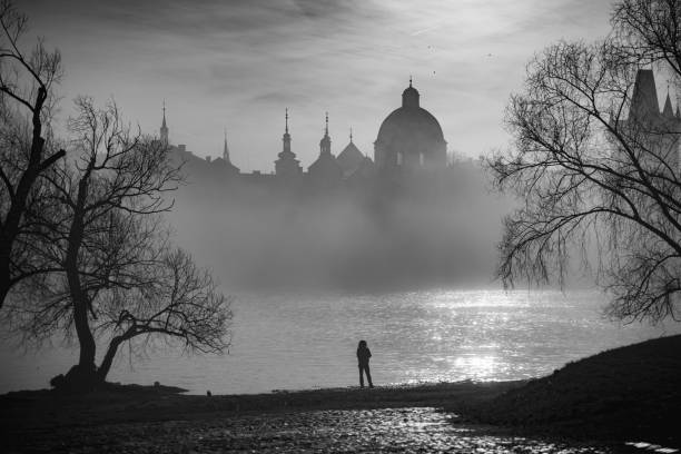 A view of the Vltava river in Prague, Czech Republic, with early morning mist descending.