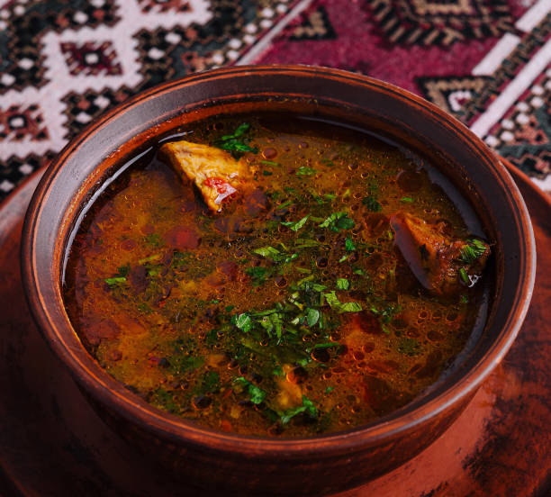 istock Traditional spicy soup in clay bowl on ethnic textile 2152024819