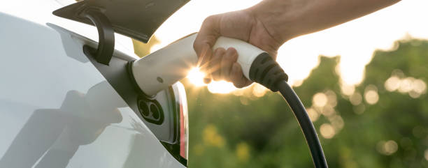 istock Man recharging battery for electric car during road trip. Exalt 2152027793