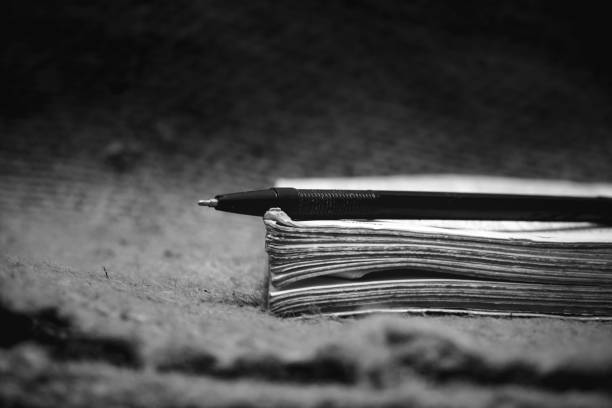 a pen lying on top of a thick book