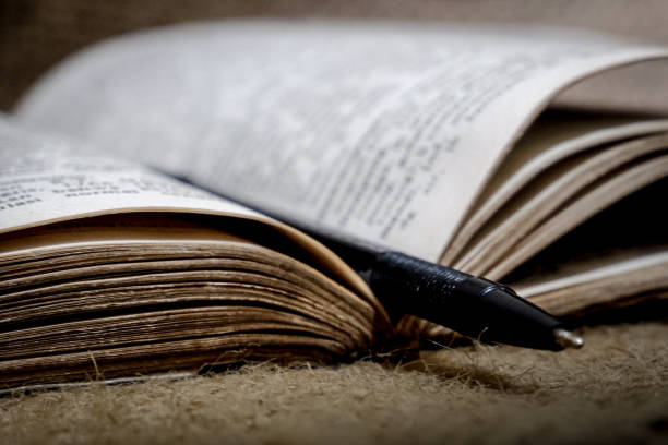 a pen on the middle page of an open book