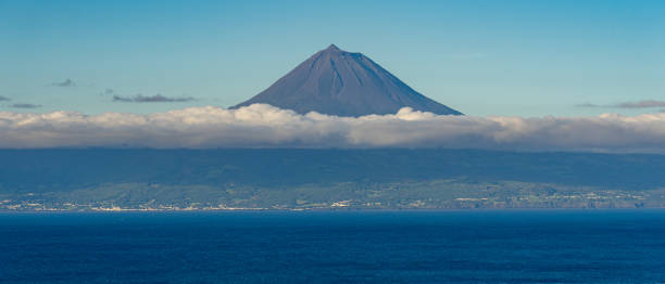 istock Peak mountain with cloud ring at the bottom and clear sky at the top. 2152033863