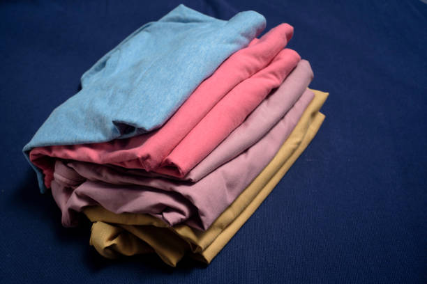 Multi color cloth shirts folded in a heap