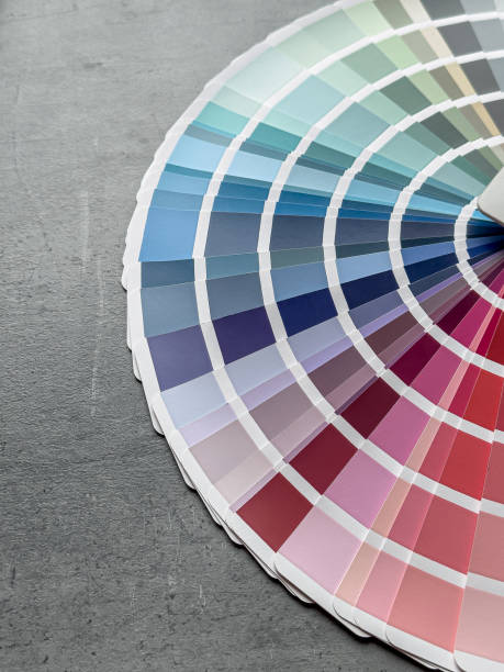 istock catalog of paints with different samples on grey desk.  Rainbow sample colors catalogue. 2152034715