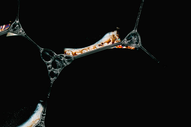 istock Close-up of soap foam bubbles with iridescent surface areas on a black background 2152034777