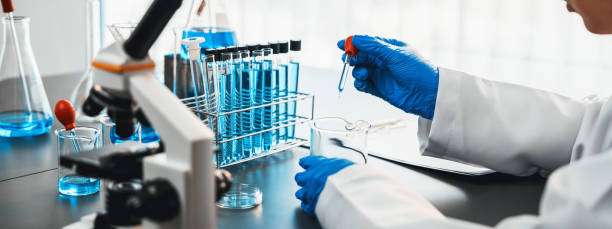 Scientist conduct chemical experiments in laboratory. Neoteric