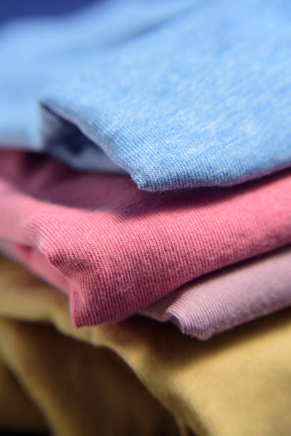 istock Multi color cloth shirts folded in a heap 2152036802