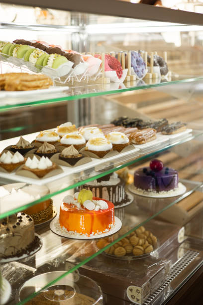 istock Sweet Selection: Muffins, Eclairs, Donuts, and More on Display in Coffee Shop Showcase 2152037906