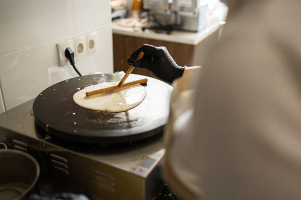 Crafting Pancake Delights: Unrecognizable Woman at Little Bakery Kitchen