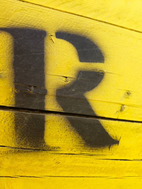 istock letter R painted on yellow wooden background 2152039009