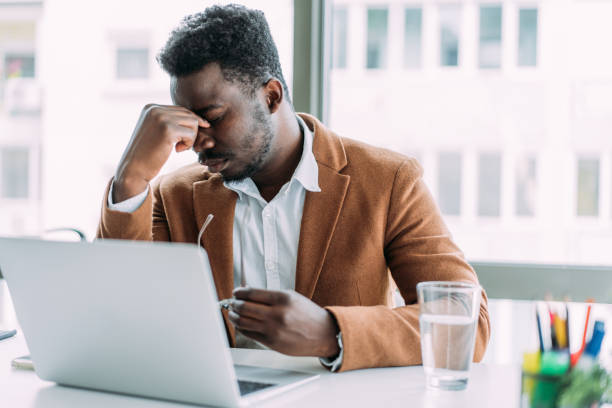 istock Stressed businessman having headache while working on laptop in the office. 2152040299