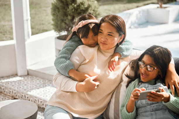 istock Digital Delight: Mom and daughters Bonding Outdoors 2152040468