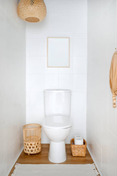 istock Classic ceramic toilet with covered plastic lid over seating in small bathroom 2152046726