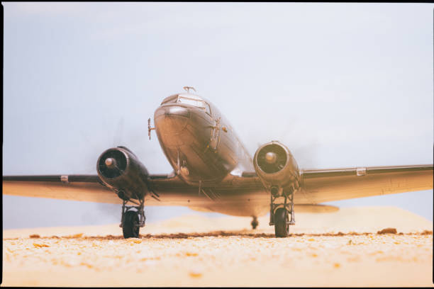 A scale model of the iconic bare-metal DC-3 Dakota in the desert.
