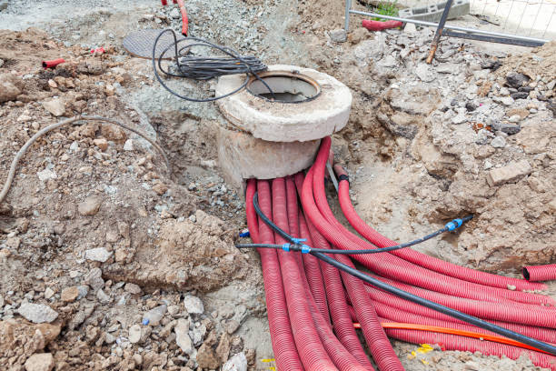 istock Laying communications in the ground using red corrugated hoses. 2152047553