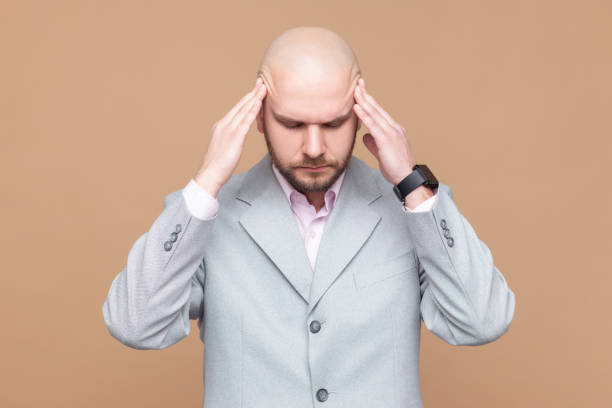 istock Sick ill unhealthy man standing with hands on head, keeps eyes closed, suffering terrible headache. 2152048896