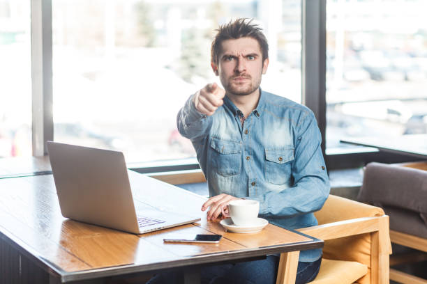 istock Strict bossy handsome man freelancer working on laptop, pointing at camera, selecting you. 2152049008