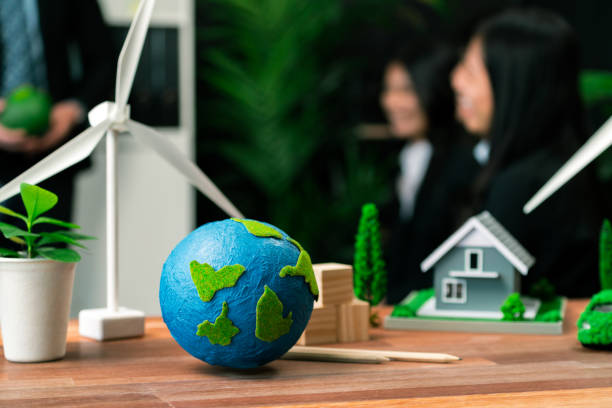 istock EV car model with mockup wind turbine on blurred background meeting. Quaint 2152049021