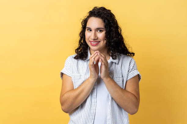 istock Woman clasping hands and smirking mysteriously, scheming cheats, evil prank. 2152049934