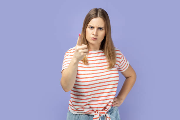 istock Woman pointing finger and looking with dissatisfied suspicious expression, warning about troubles. 2152050248