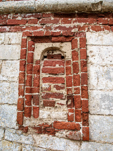 istock An ancient loophole in the fortress wall walled up with bricks 2152055449