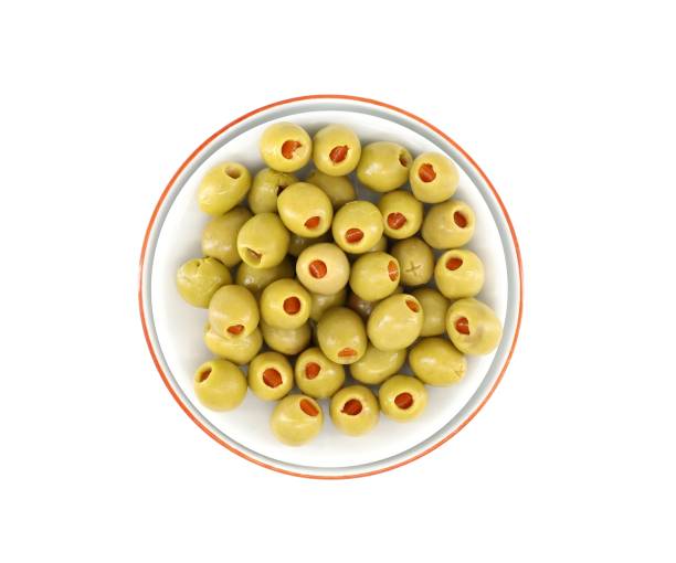 Green olives stuffed with red peppers in a bowl