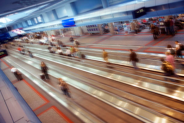 Moving walkway between United Airlines A and B gates in Terminal 1 at O'Hare International Airport in Chicago. Beautiful moody colorful lighting