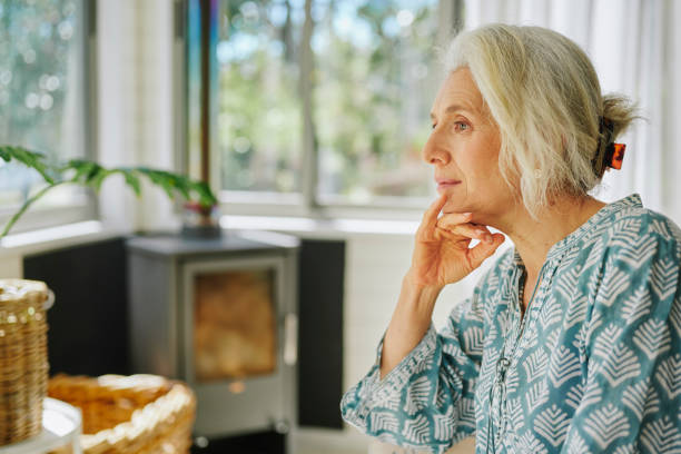istock Mature woman lost in thought while relaxing at home 2152060815
