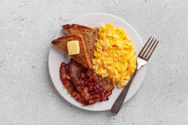 istock traditional scrambled egg breakfast with bacon and toast 2152063719
