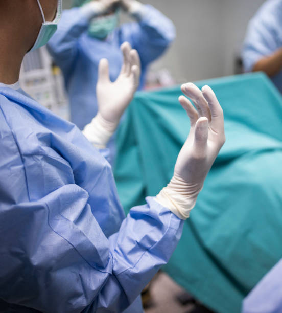 istock Surgeons wearing gloves ready to perform an operation on a patient 2152063878
