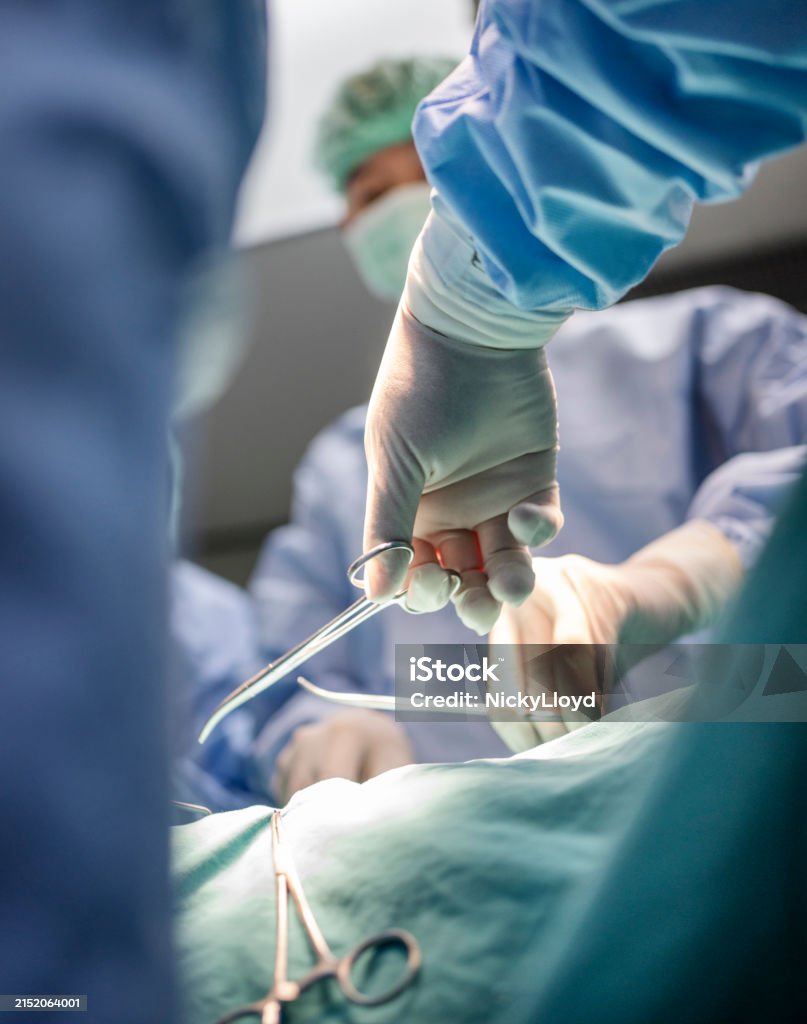 Using Forceps Surgeons Using Forceps During An Operation On A Patient Stock Photo ...
