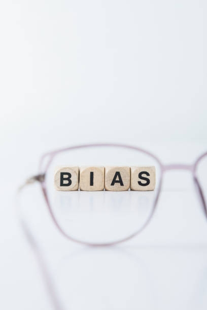 Cubes forming the word bias viewed through a lens