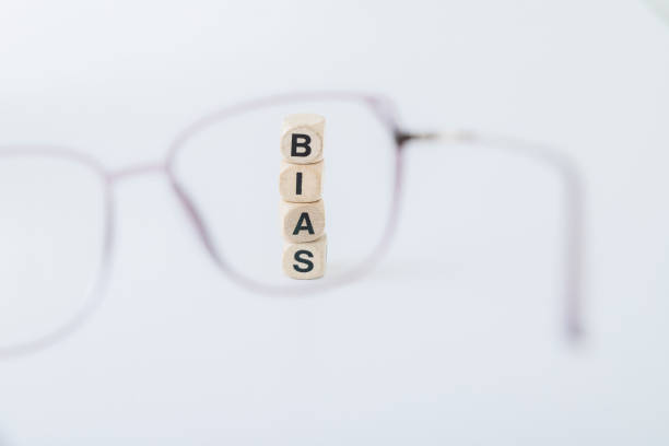 istock Cubes forming the word bias viewed through a lens 2152064233