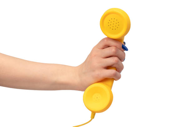istock Yellow handset in woman hand isolated on white. Copy space. 2152064530