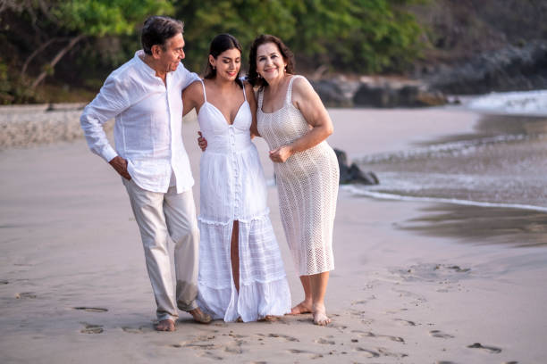 Beautiful latin family, spending a good time with so much love in the beach during the sunset