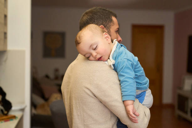 istock A man is holding a sleeping baby 2152066823