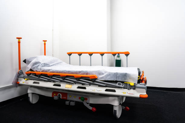 Motion blurring effect while hospital emergency with patient lying on gurney and medical personnel pushing it. Work of emergency medical team