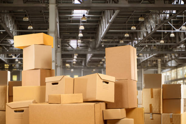 istock Pile of cardboard boxes. Industrial building with parcels. Boxes inside hangar. Parcels for storing things. Archival boxes with papers. Pile parcels inside production building. Safekeeping, logistics 2152070579