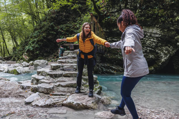 istock Diverse Female Friends Hiking in Forest by River 2152070743